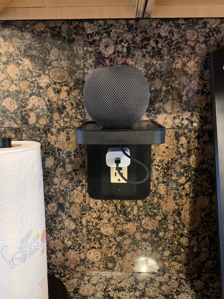 An Allicaver Outlet Shelf for a Decora Outlet installed with an Apple HomePod mini sitting on the built-in shelf